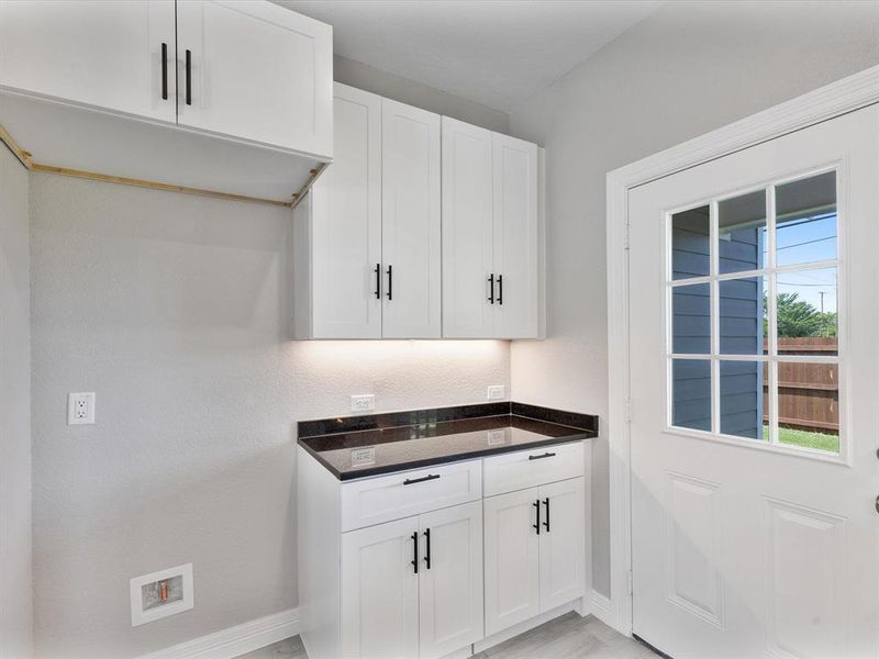 Kitchen with baseboards and white cabinets Kitchen with baseboards and white cabinets
