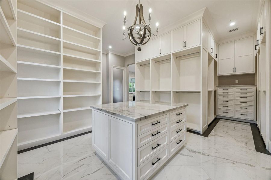 HIS CLOSET WITH PACKING ISLAND