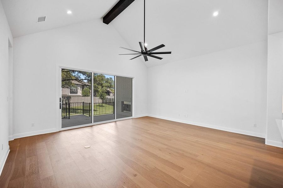 Spare room featuring high vaulted ceiling, beamed ceiling, a ceiling fan, wood finished floors, and recessed lighting Spare room featuring high vaulted ceiling, beamed ceiling, a ceiling fan, wood finished floors, and recessed lighting