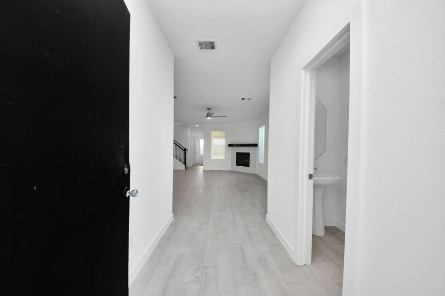 As you step into the threshold of this luxurious home, you'll soon be welcomed by an elegant glass door (to be installed). Inside, soaring ceilings amplify the spaciousness, while the refined wood-look tile flooring and oversized baseboards exude sophistication and charm. Sample photo of completed home with similar floor plan. Actual colors and selections may vary.