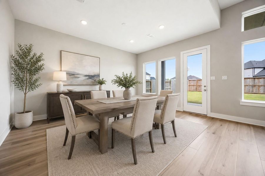 A sunlit dining area offers backyard access through glass doors, ideal for casual meals or hosting guests. Virtually staged. A sunlit dining area offers backyard access through glass doors, ideal for casual meals or hosting guests. Virtually staged.