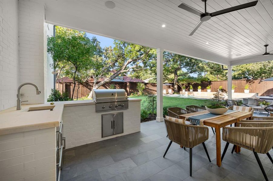 View of patio / terrace with grilling area, area for grilling, sink, and ceiling fan