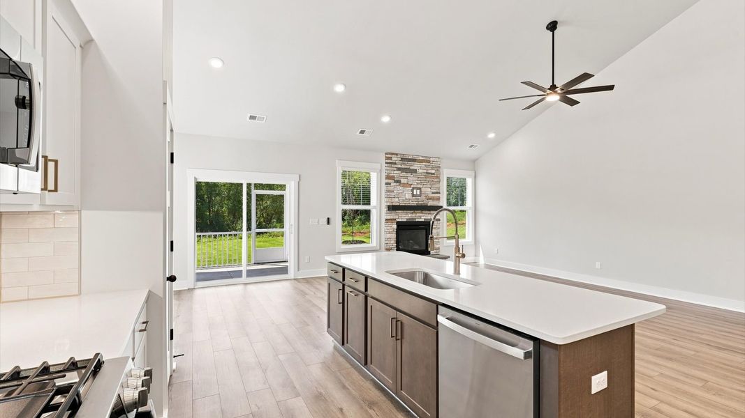 Gourmet-inspired kitchen with expansive island and seamless open-concept flow by DRB Homes