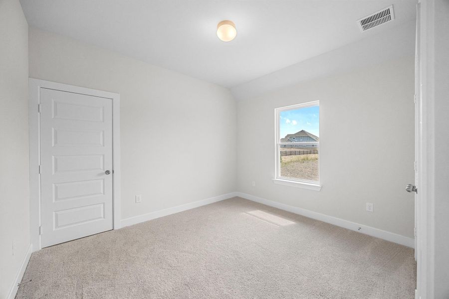 Empty room with carpet floors and baseboards