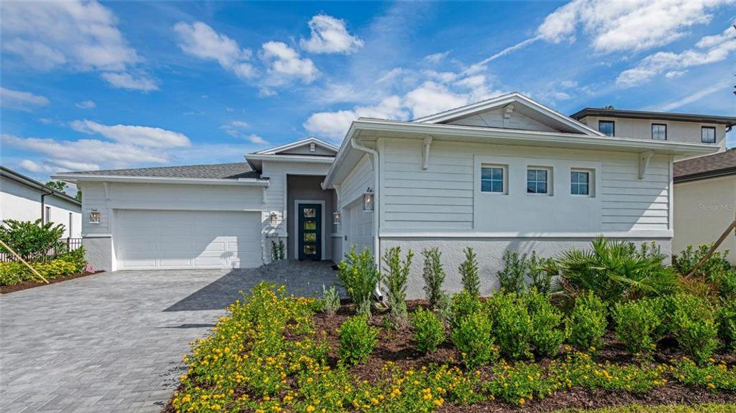 Front exterior of a new home in Cresswind DeLand, Deland, FL, highlighting curb appeal (Image 1). Front exterior of a new home in Cresswind DeLand, Deland, FL, highlighting curb appeal (Image 1).