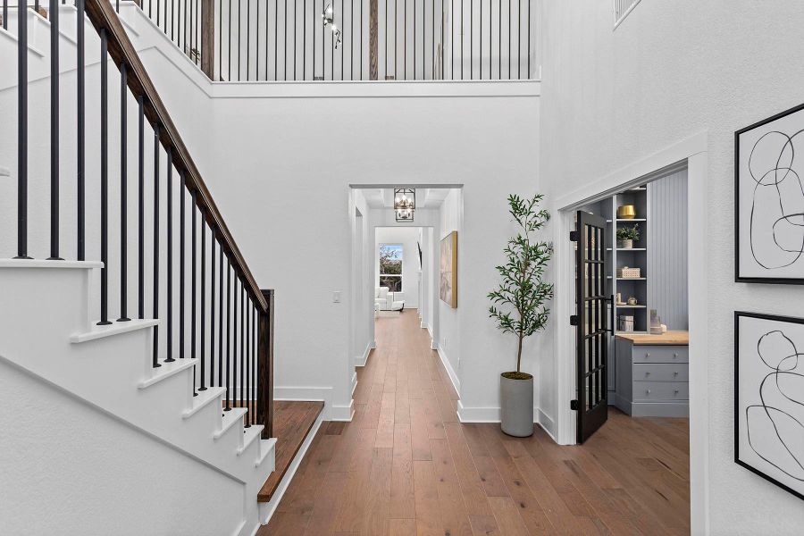 Foyer entrance featuring wood-type flooring and a high ceiling