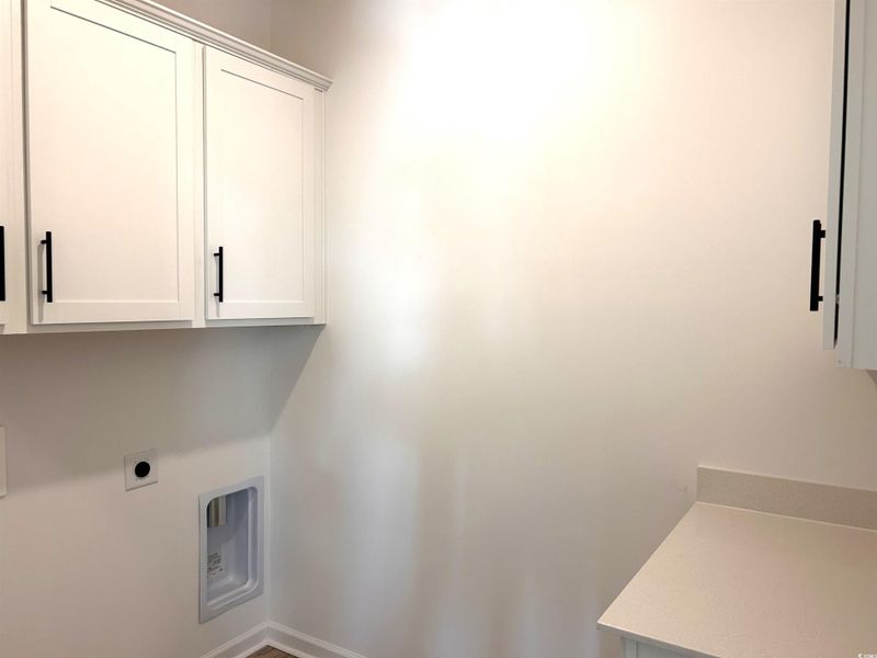 Washroom featuring cabinet space and hookup for an electric dryer