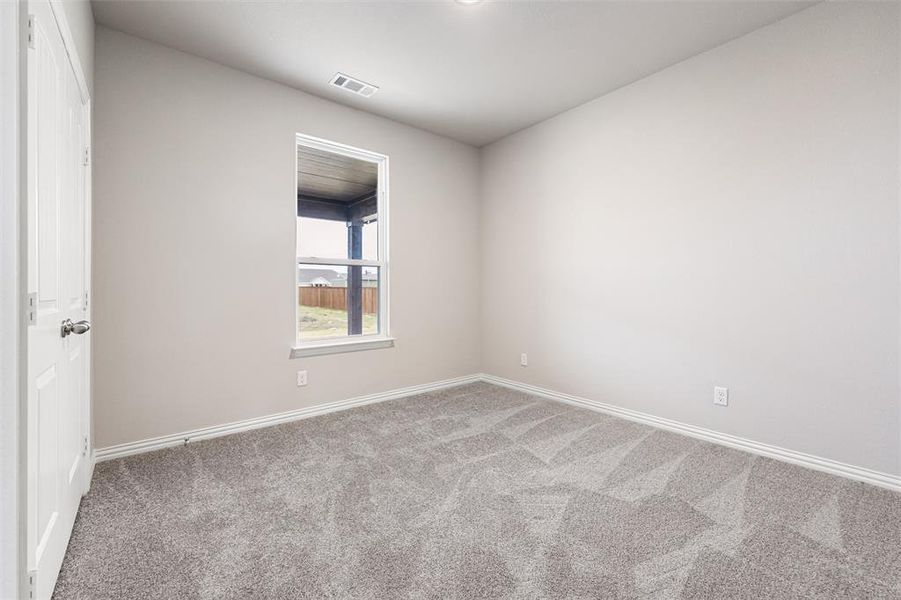 Carpeted empty room with baseboards