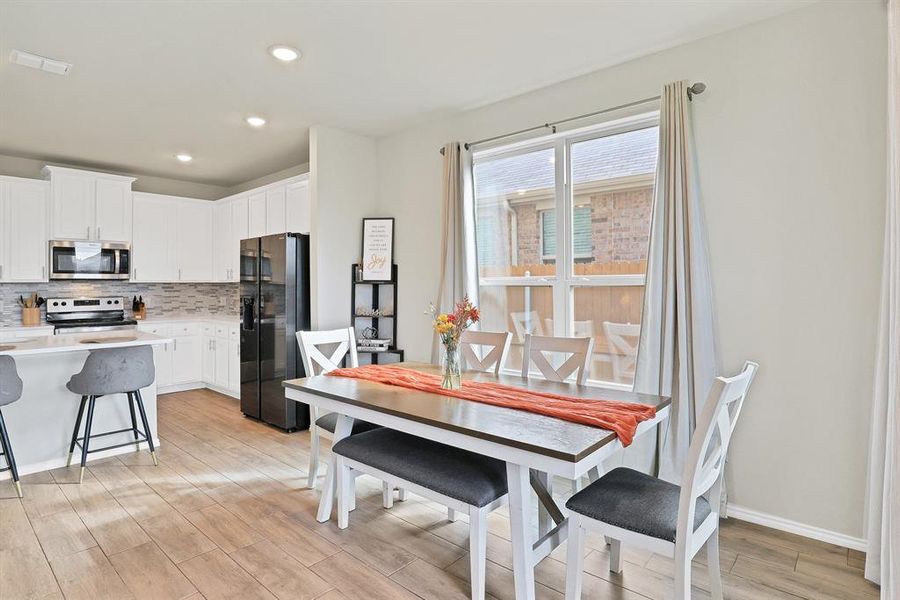 Dining space with light wood-type flooring