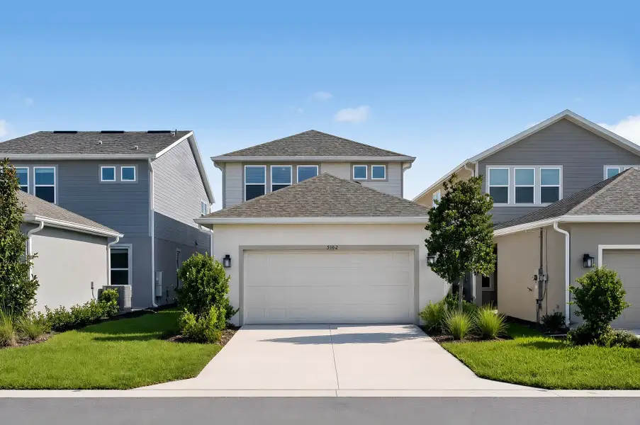 Front exterior of a new home in Center Lake Ranch Community Group Page, St. Cloud, FL, highlighting curb appeal (Image 2). Front exterior of a new home in Center Lake Ranch Community Group Page, St. Cloud, FL, highlighting curb appeal (Image 2).