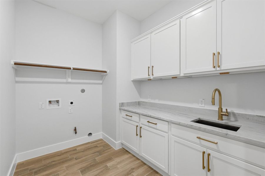 Your utility room is located right off the garage entry for the perfect mudroom! It features it's own soaker sink and folding counter as well as plenty of extra storage space!