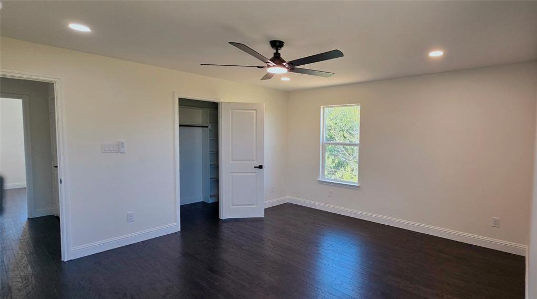 Unfurnished bedroom with dark wood-type flooring, ceiling fan, a closet, and recessed lighting Unfurnished bedroom with dark wood-type flooring, ceiling fan, a closet, and recessed lighting