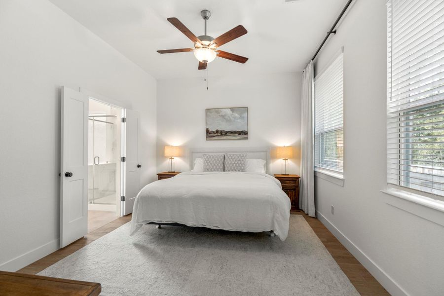 This elegant primary suite offers scenic backyard views and stylish tile flooring. This elegant primary suite offers scenic backyard views and stylish tile flooring.