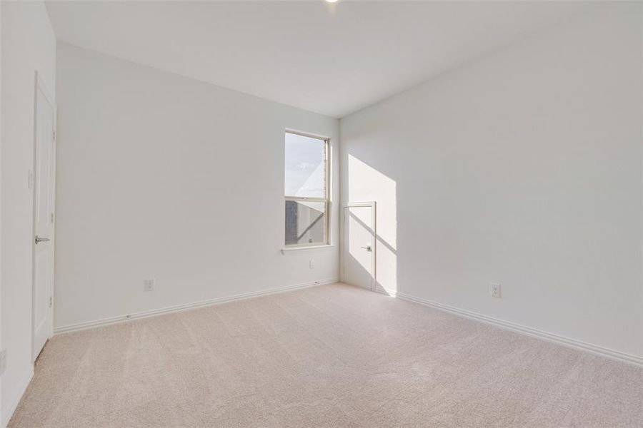 Unfurnished room featuring light carpet