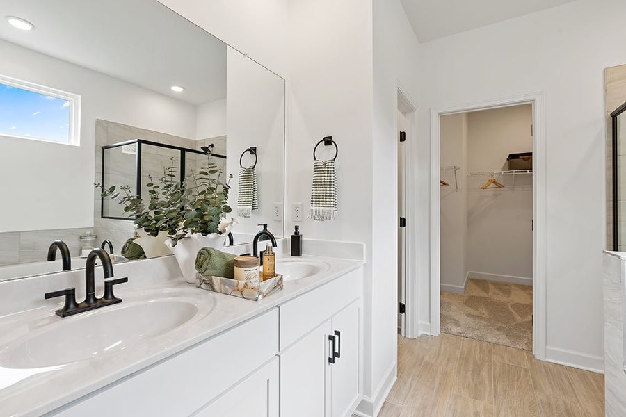 A bathroom with a sink and a mirror. A bathroom with a sink and a mirror.
