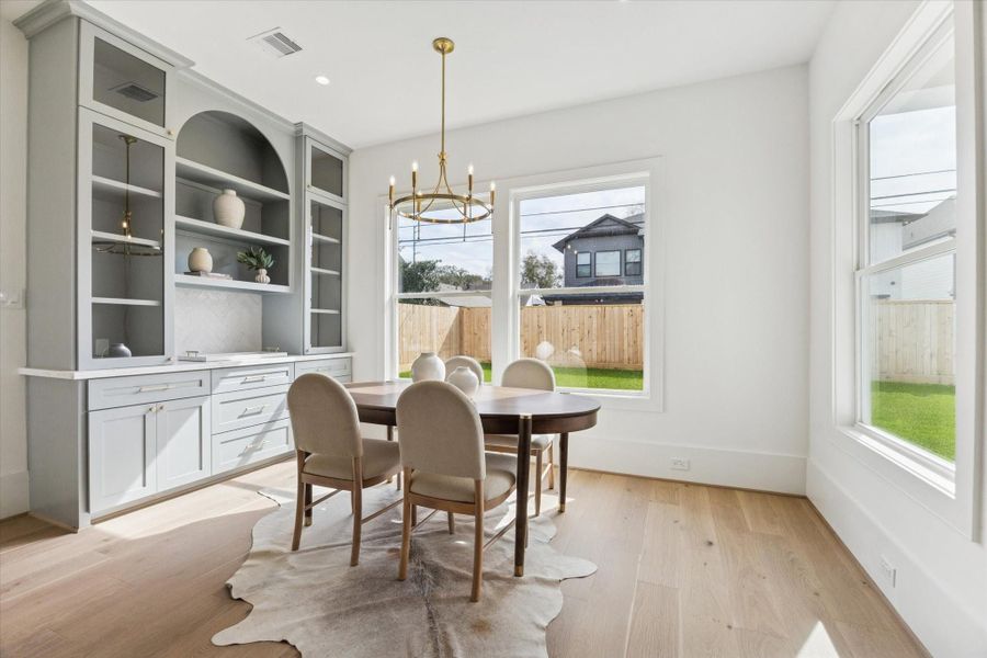 Light-filled morning room with backyard views and easy access to the covered patio.