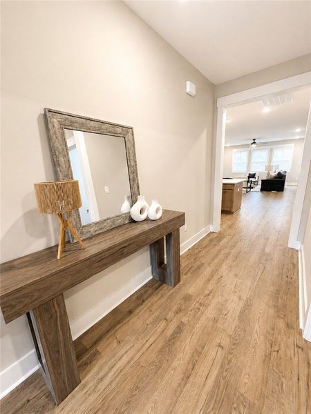 A welcoming entryway with sleek wooden flooring le A welcoming entryway with sleek wooden flooring le