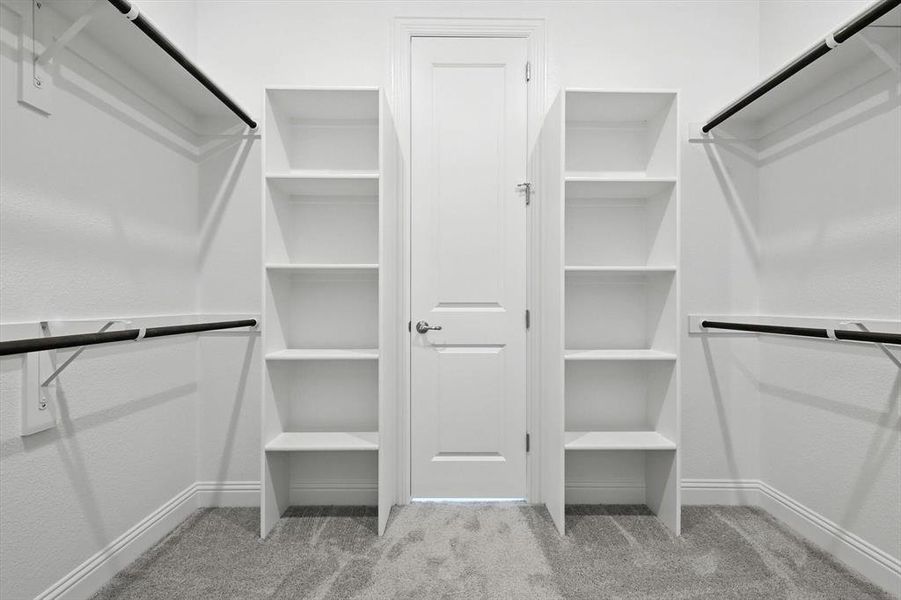 Spacious closet with carpet flooring Spacious closet with carpet flooring