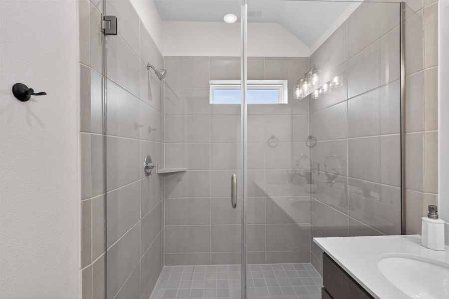 Spa-inspired walk-in shower with sleek tile surround, glass enclosure, and modern fixtures for a clean, elevated finish. Spa-inspired walk-in shower with sleek tile surround, glass enclosure, and modern fixtures for a clean, elevated finish.