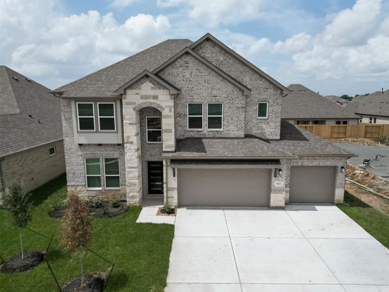 Front exterior of a new home in Foxtail Palms, Manvel, TX, highlighting curb appeal (Image 24). Front exterior of a new home in Foxtail Palms, Manvel, TX, highlighting curb appeal (Image 24).