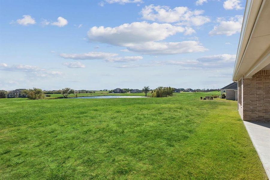 View of green lawn featuring a water view