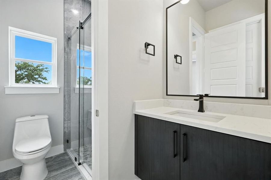 Bathroom featuring vanity and a shower stall