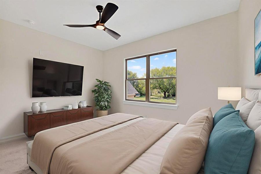 Bedroom featuring ceiling fan and carpet flooring Bedroom featuring ceiling fan and carpet flooring
