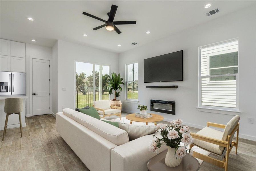 Open living area with kitchen, dining, and access to outdoor patio. Open living area with kitchen, dining, and access to outdoor patio.