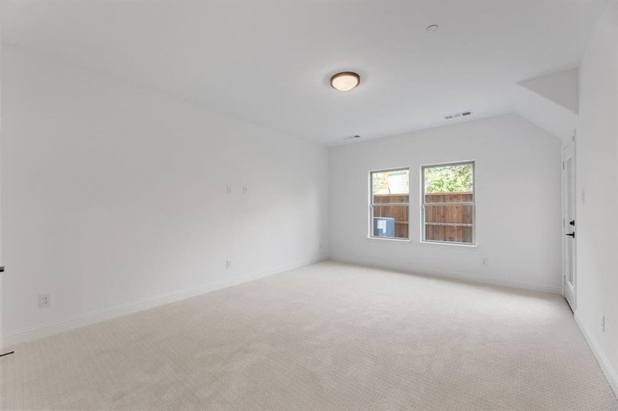 Empty room with light colored carpet and baseboards Empty room with light colored carpet and baseboards