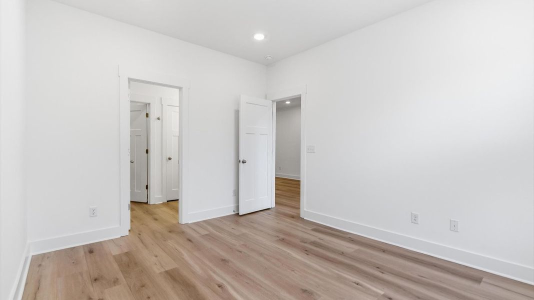 Vibrant natural light fills this exceptional primary suite with eye-catching details