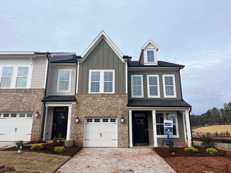Front exterior of a new home in Ovation at Sweetbrier, Durham, NC, highlighting curb appeal (Image 1).