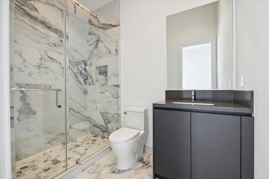 Both secondary bedrooms feature sleek ensuite baths with clean lines, high-end finishes, and sophisticated fixtures. Both secondary bedrooms feature sleek ensuite baths with clean lines, high-end finishes, and sophisticated fixtures.