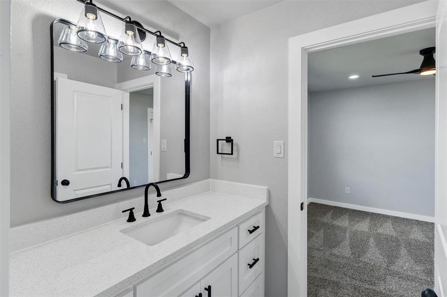 Bathroom featuring vanity and a ceiling fan