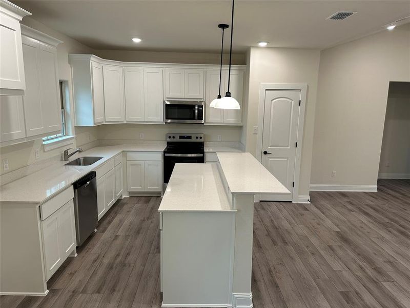 Kitchen with plenty of cabinets and countertops.