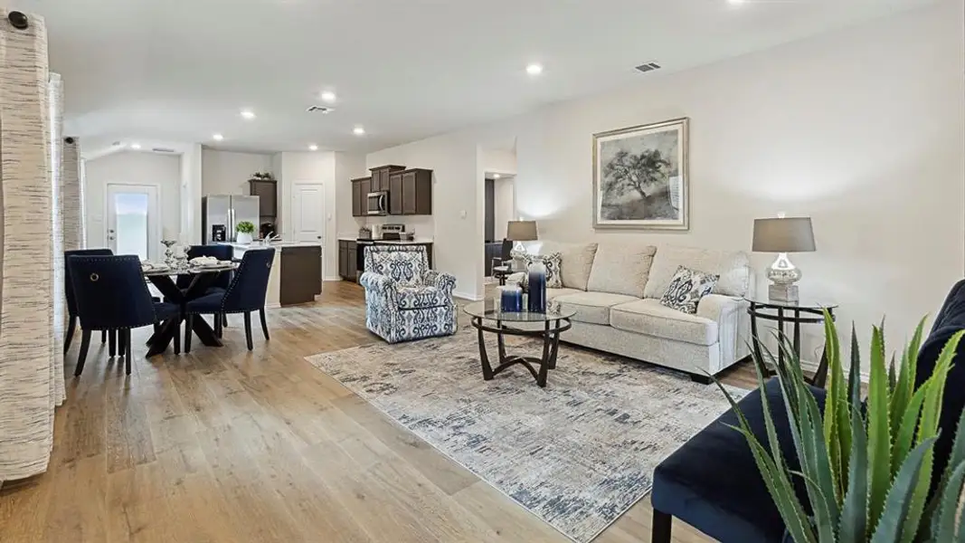 Living room featuring light wood-style flooring, recessed lighting, and vaulted ceiling Living room featuring light wood-style flooring, recessed lighting, and vaulted ceiling