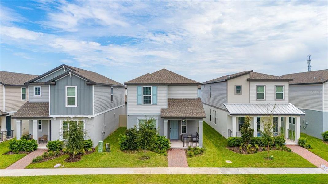 Front exterior of a new home in Highland Ridge, Winter Garden, FL, highlighting curb appeal (Image 22).
