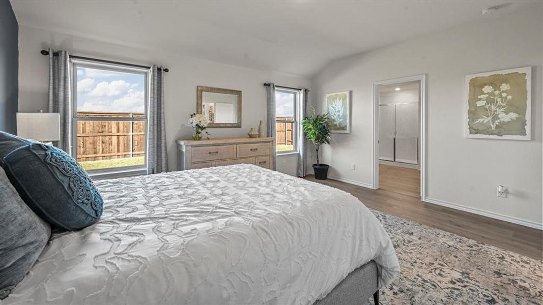 Bedroom featuring vaulted ceiling and dark wood finished floors