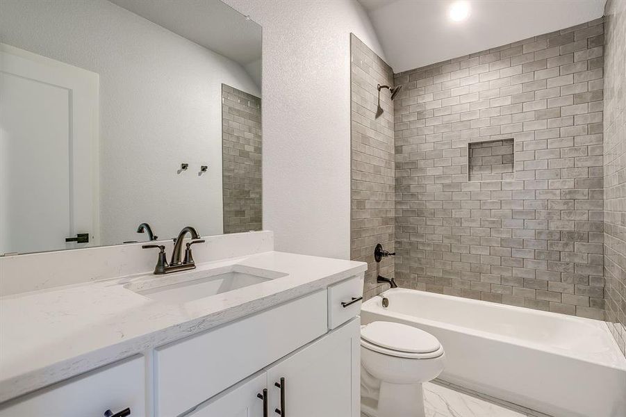 Full bath with vanity, shower / bathtub combination, and a textured wall