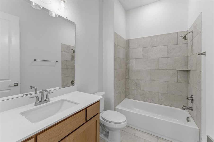Full bathroom featuring a single vanity with wood cabinetry, a white countertop, and an undermount sink