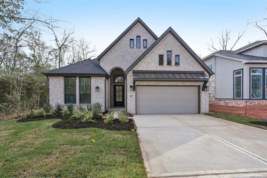 Front exterior of a new home in Alsatian Oaks, Castroville, TX, highlighting curb appeal (Image 1). Front exterior of a new home in Alsatian Oaks, Castroville, TX, highlighting curb appeal (Image 1).
