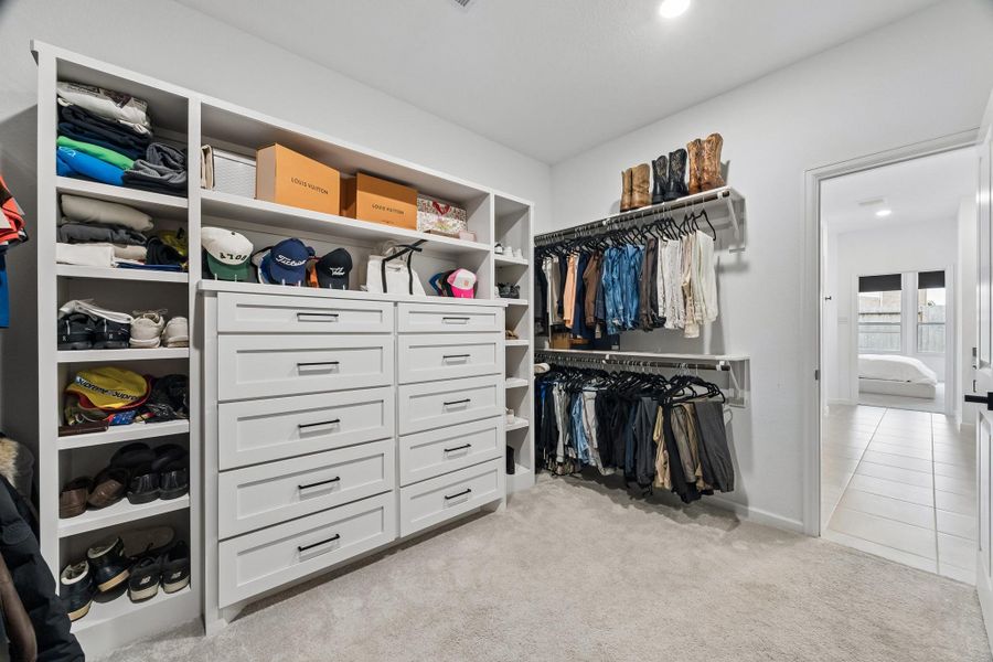 The primary closet had built-in shelves and cabinets added for ample organizaion and storage. There was also shelves added above each hanging rack. The primary closet had built-in shelves and cabinets added for ample organizaion and storage. There was also shelves added above each hanging rack.