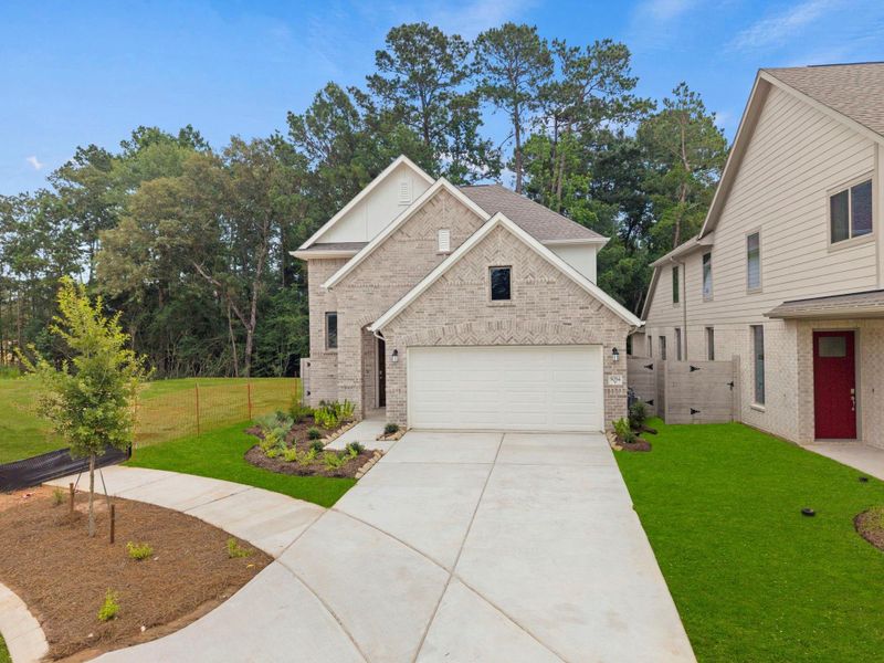 Front exterior of a new home in Two Step Farm, Montgomery, TX, highlighting curb appeal (Image 2). Front exterior of a new home in Two Step Farm, Montgomery, TX, highlighting curb appeal (Image 2).