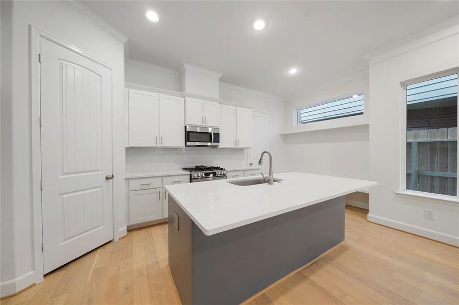 Another view of the beautiful kitchen and mud room! The Chesapeake Kitchen seamlessly transitions into the dining room & living room. (Sample photos of a completed Chesapeake floor plan. The image may feature alternative selections and/or upgrades.)