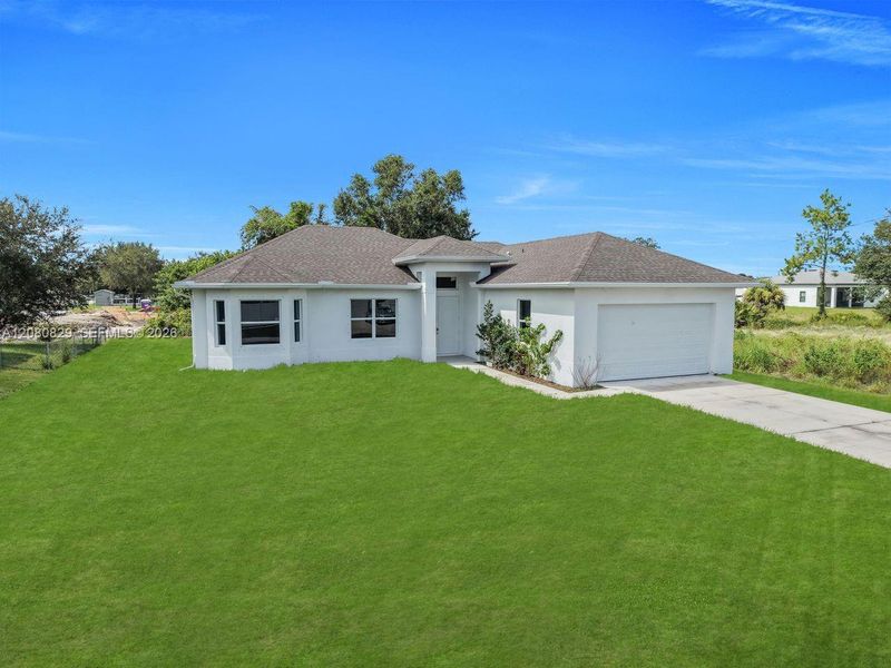 Front exterior of a new home in , Lehigh Acres, FL, highlighting curb appeal (Image 18).