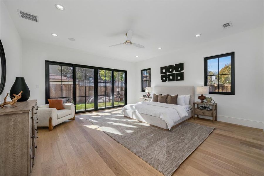 Spacious room featuring wood-finish flooring, recessed lighting, and a contemporary ceiling fan