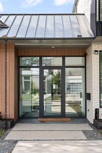 The covered entry welcomes you with clean lines and modern architectural detail.
