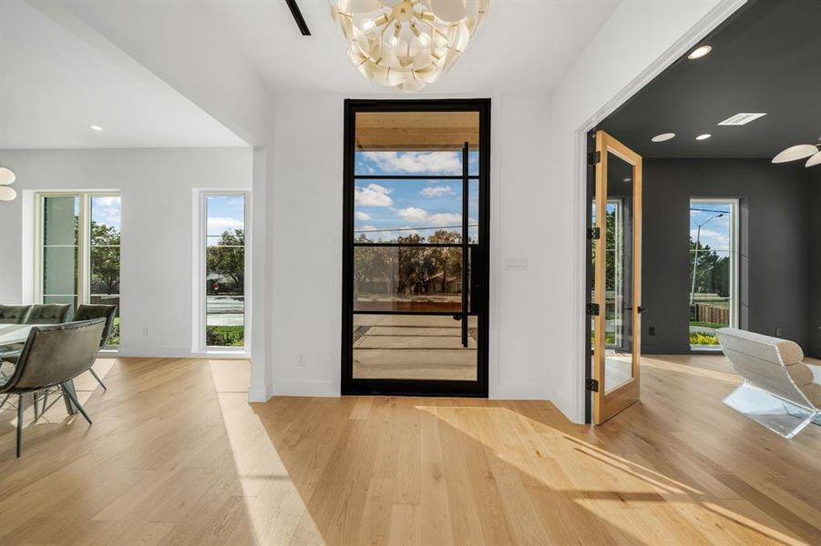 Entryway featuring a chandelier, recessed lighting, light wood-style floors, and plenty of natural light