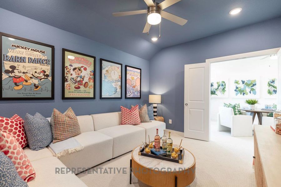 Carpeted living room featuring recessed lighting, ceiling fan, and vaulted ceiling