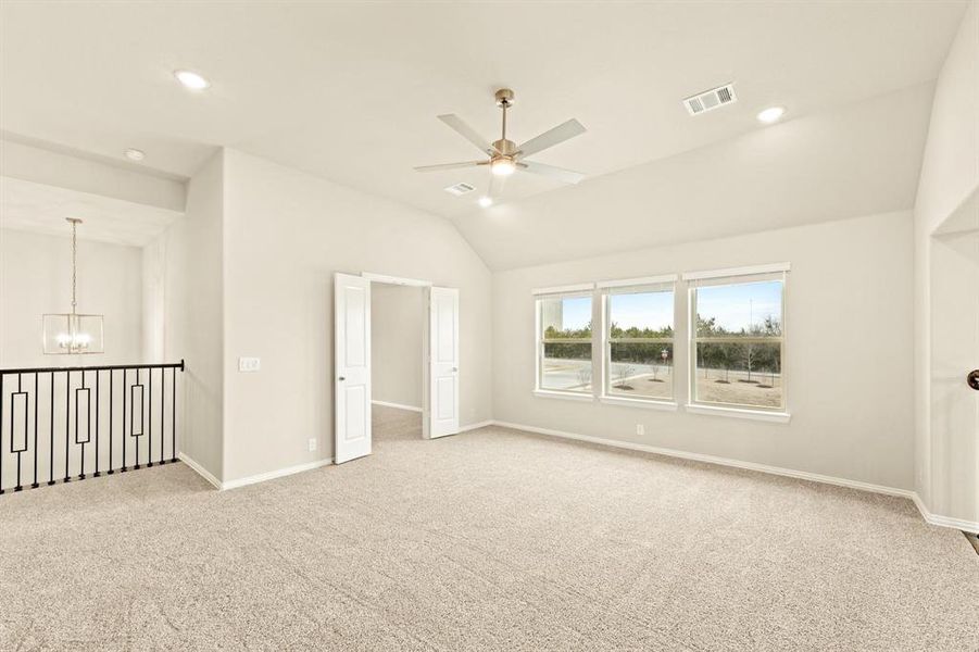Empty room with vaulted ceiling, a chandelier, light carpet, a ceiling fan, and recessed lighting