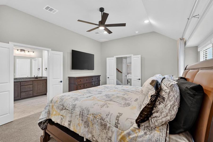 Vaulted ceiling bedroom featuring a dark wood-finish ceiling fan with integrated lighting, recessed lighting, and soft gray wall tones Vaulted ceiling bedroom featuring a dark wood-finish ceiling fan with integrated lighting, recessed lighting, and soft gray wall tones